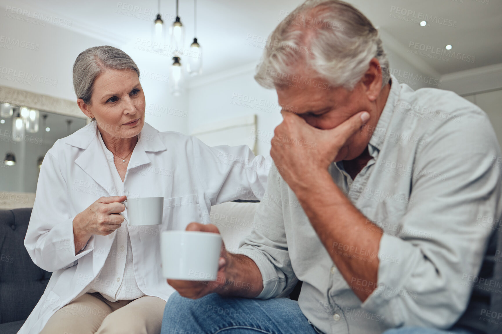 Buy stock photo Coffee, depression and support with a senior man talking to a doctor while on a sofa together. Cancer, sad and mental health with a mature patient and woman showing compassion in a retirement home