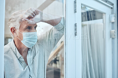 Buy stock photo Lonely, face mask and senior man in the house for quarantine, protection and isolation during pandemic. Depression, frustrated and sad elderly guy with covid looking outside the window at his home.