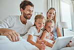 Family, bed and tablet with children and parents streaming an online subscription in the bed at home. Kids, internet and video with a man, woman and daughter siblings watching series in the bedroom