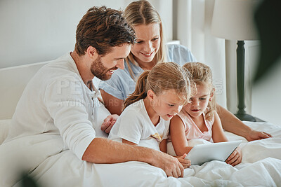 Buy stock photo Happy, family and tablet for entertainment on the bed watching shows together while relaxing at home. Mother, father and children relax with smile for online streaming on touchscreen in the bedroom