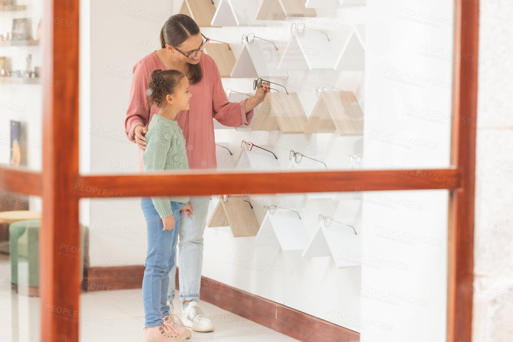 Buy stock photo Glasses, vision and family with a mother and daughter customer shopping for prescription lenses at an optician. Eyewear, optometry and retail with a woman and girl buying new frame spectacles