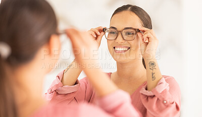 Buy stock photo Vision, mirror and happy woman trying on glasses to choose a new frame at an optometry store. Smile, eyewear and lady choosing spectacles with a prescription lens after an eye exam at optical clinic,