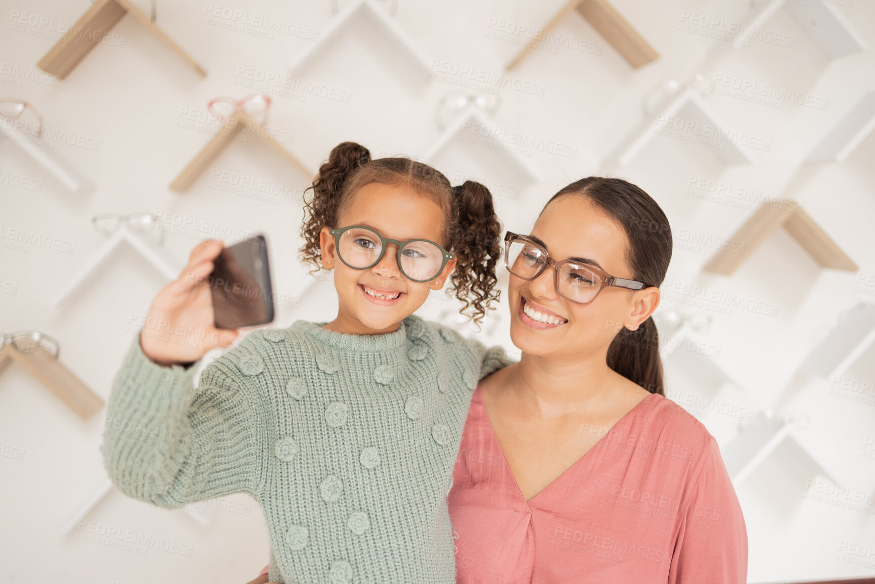 Buy stock photo Phone, mother and child take a selfie at optometrist in new glasses after shopping for a family discount. Smile, mom and happy girl buying new frames for better eyesight or vision at a retail store