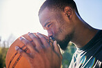 Black man, basketball and kiss for sports love, passion or dedication in motivation, good luck or praise on the court. African American male basketball player kissing lucky ball for score or point