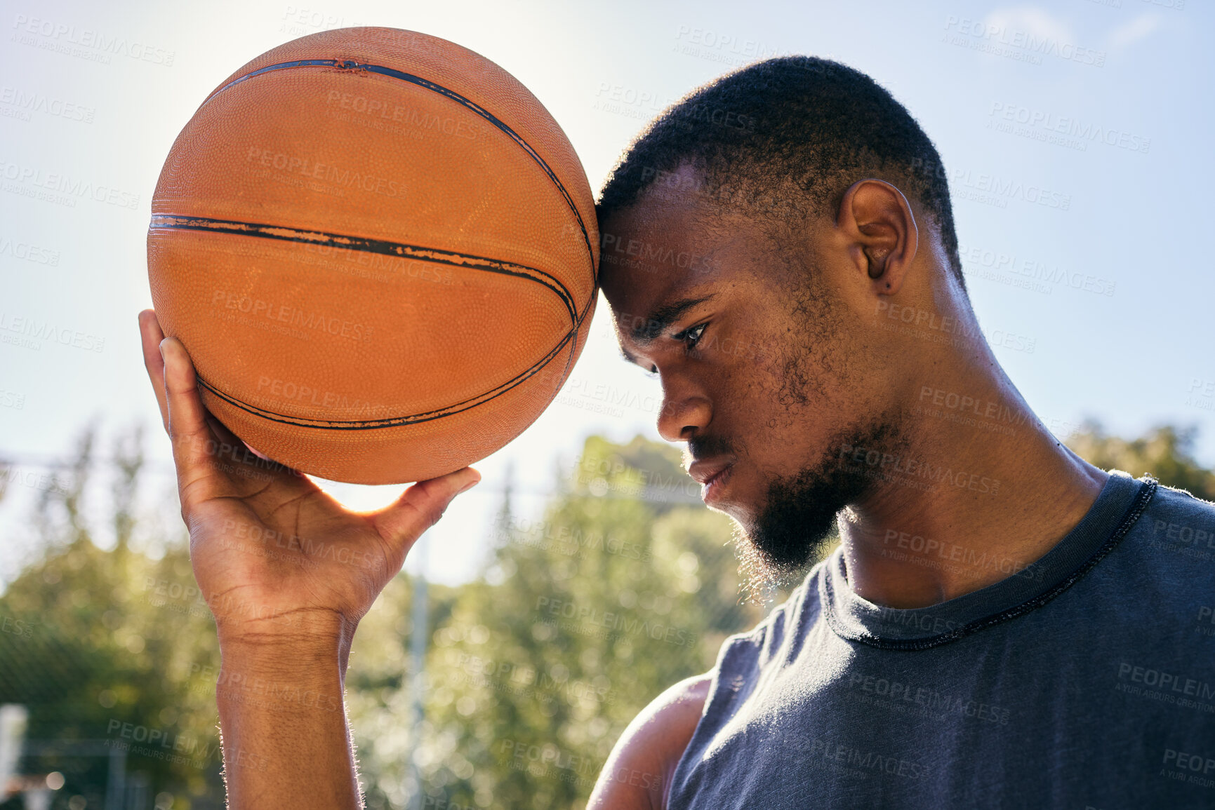 Buy stock photo Basketball on forehead, motivation and black man on basketball court ready for competition, match or game. Basketball player, sports and male from Nigeria preparing for training, fitness or exercise.