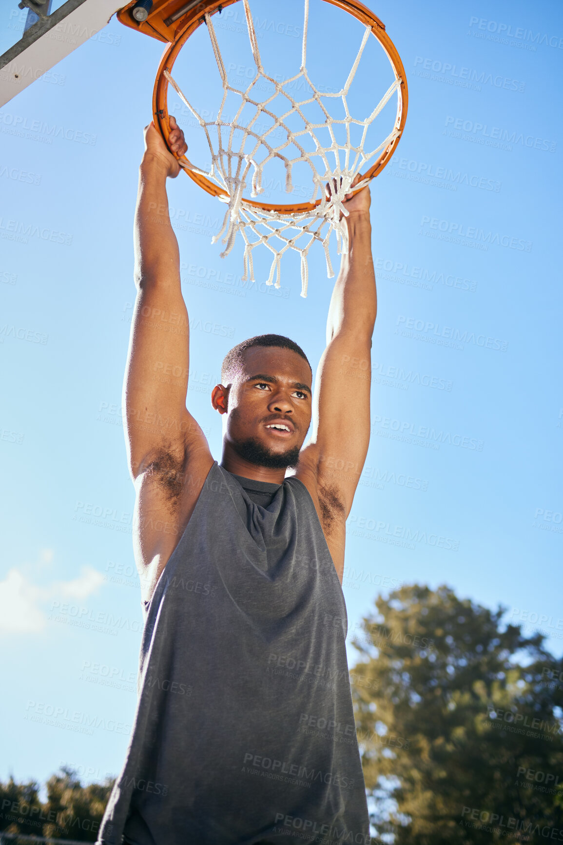 Buy stock photo Basketball, sports and black man hanging on hoop at a game during summer. Energy, action and African athlete thinking at a basketball court with motivation and commitment to outdoor urban sport
