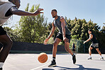 Fitness, basketball and athlete on an outdoor court playing a match or training as a team. Motivation, exercise and healthy basketball player practicing with a ball for a sports game in South Africa.