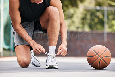 Buy stock photo Basketball, shoes and hands by man on the ground for lace before exercise, training and cardio at a basketball court. Fitness, sneakers and basketball player getting ready for workout, sport and game