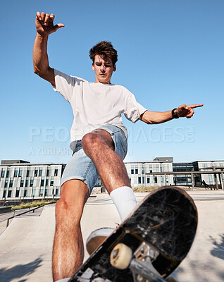 Buy stock photo Skateboard, city and sports with a man outdoor in summer for recreation or fun while skating alone. Street, skater and energy with a young male skateboarding or riding a board in an urban town