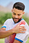 Sports, football and man with shoulder pain, injury or training accident from competition, exercise or fitness workout. Game emergency, muscle problem and athlete soccer player hurt on soccer field