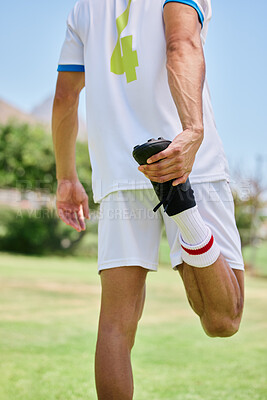 Buy stock photo Soccer, sports and athlete stretching his leg before a match, training or practice on an outdoor field. Football, workout and man doing a warm up exercise for game or workout on a pitch at a stadium.