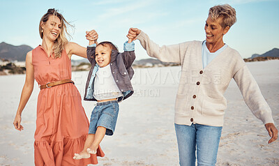 Buy stock photo Happy, mother and grandmother holding hands with child at the beach for fun family time together in the outdoors. Mama, grandma and kid swinging in the air for playful walk at the sandy ocean outside