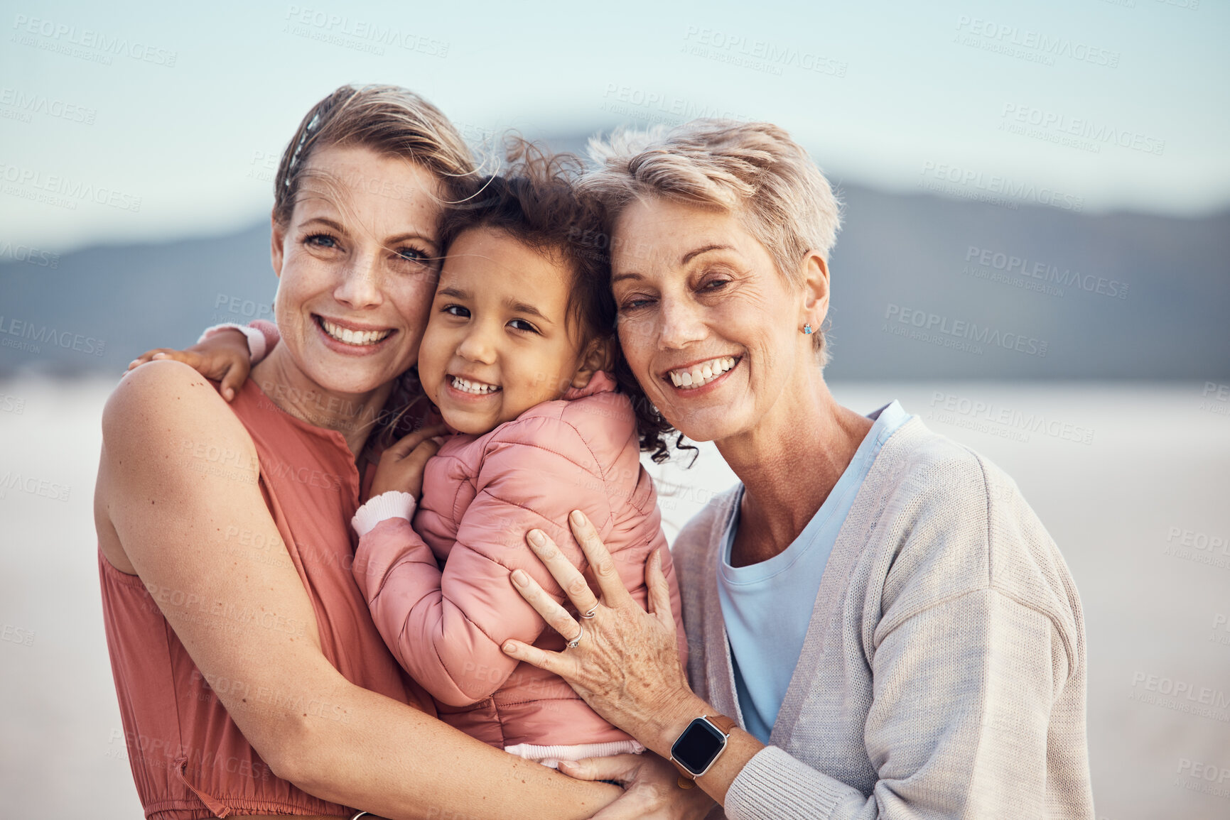 Buy stock photo Happy family generation, beach hug and portrait of grandmother, mother and adoption child bonding, relax and enjoy quality time together. Winter peace, freedom and family love of grandma, mom and kid