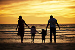 Family, holding hands and silhouette at the beach at sunset, adventure and love with parents and children outdoor. Mother, father and kids together, trust and freedom by the ocean, nature and care.