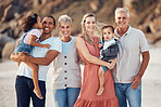 Interracial family, smile and children together on a beach bonding with happiness and kid care. Portrait of a happy, vacation and parents with senior grandparents holding kids with love outdoor