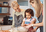 Grandma, mother and child baking in kitchen together while girl learns to mix cake mixture, pancake batter or muffin mix. Family cooking dessert, kid learning and cooking snack food for home dinner  