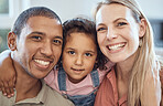 Happy, smile and interracial parents with their child sitting, bonding and relaxing together. Portrait of a mother, father and girl kid with happiness, love and care on a sofa in their family home.