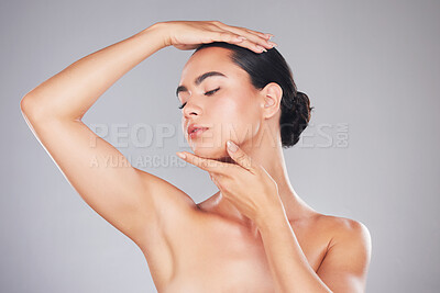 Buy stock photo Woman, beauty and model in skincare, cosmetics or facial treatment posing against a grey studio background. Beautiful elegant female touching soft smooth face or head for skin or body care on mockup