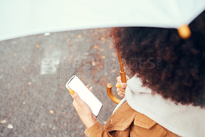 Buy stock photo Phone, woman with umbrella and blank screen for marketing, advertising or product placement in city streets. Young black girl, smartphone for social media and outside in autumn with mobile tech