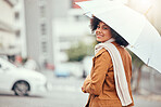 Winter, smile and woman with an umbrella for the rain while walking in the city of Portugal. Street, happy and young girl with autumn fashion on a walk in the road for peace, calm and happiness