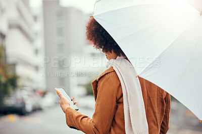 Buy stock photo Umbrella, phone and woman in a street during rain, winter and morning in the city while texting, waiting and checking message. Commute, business woman waiting for taxi in rainy weather in New York