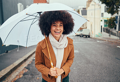 Buy stock photo Rain, umbrella and city with a walking black woman in the street during a cold or wet winter day. Water, insurance and cover with a young afro female outdoor for a walk in an urban town road