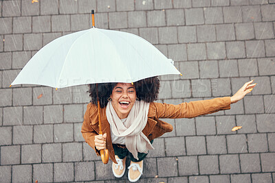 Buy stock photo Black woman, umbrella and rain with smile, happy and enjoy weather in city being wet. Winter, young female and happiness for storm, cheerful and joyful with cover, comfortable and rainy outdoor.