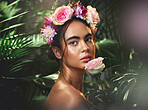 Beauty, flowers and woman with a crown in studio for skincare, cleaning and wellness with product from nature. Portrait, rose and girl model relax, pamper and cosmetic treatment, jungle and aesthetic