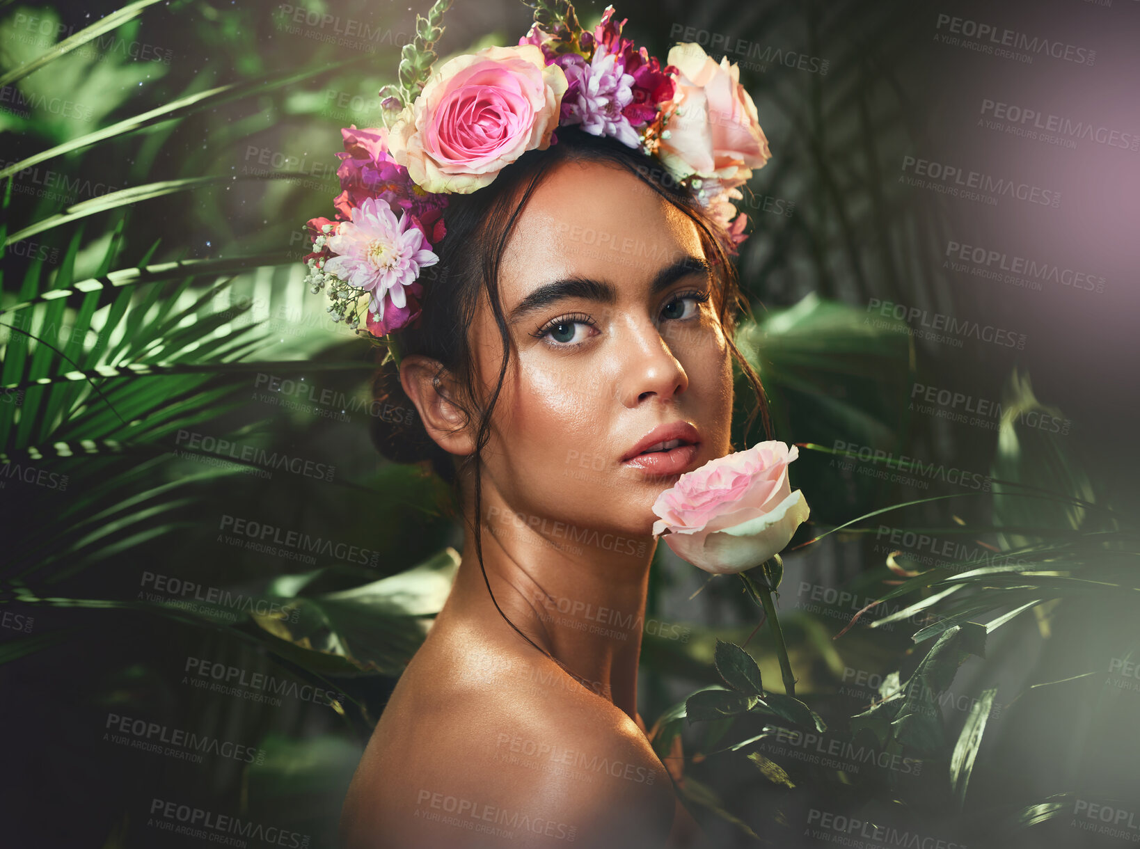 Buy stock photo Beauty, flowers and woman with a crown in studio for skincare, cleaning and wellness with product from nature. Portrait, rose and girl model relax, pamper and cosmetic treatment, jungle and aesthetic