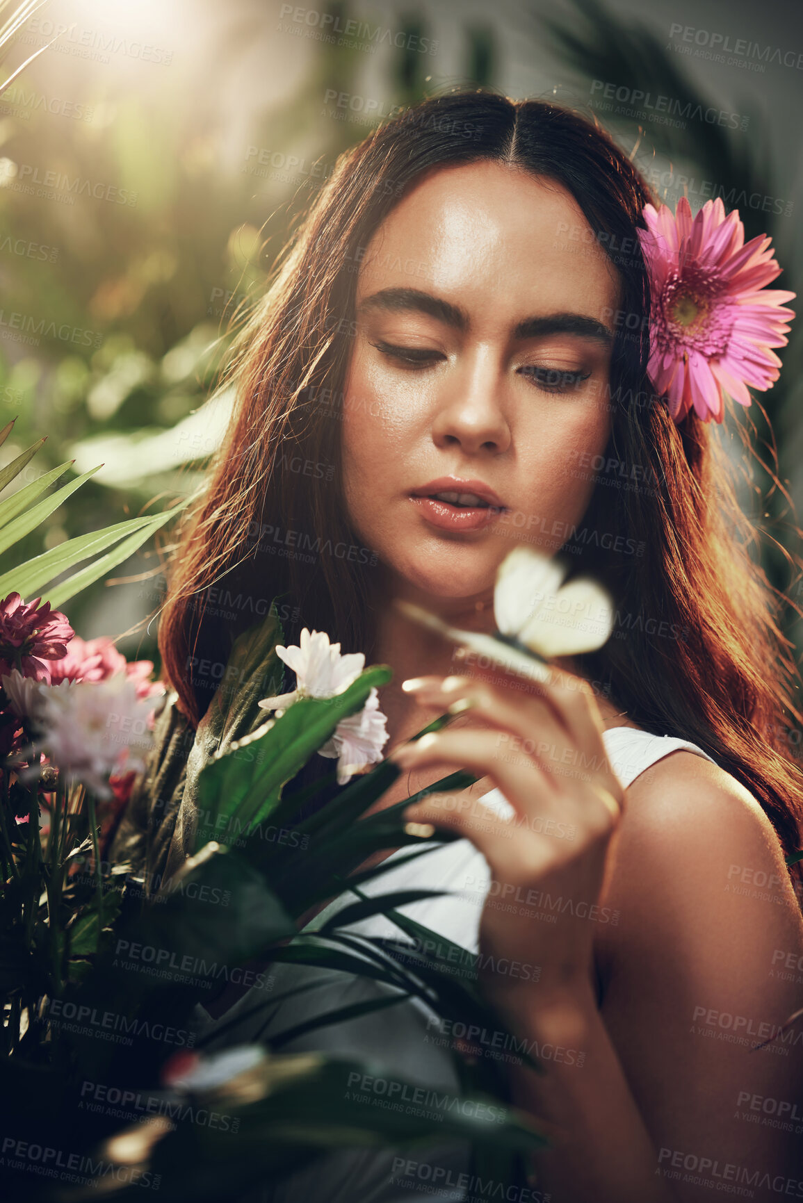 Buy stock photo Flowers, natural and woman in a garden during spring for peace, zen and beauty with plants. Summer, gardening and nature girl with flower for ecology in a forest, woods or bush environment to relax