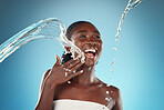 Water splash, laughing black woman and beauty on blue background of skincare, wellness or body cleaning, shower or hygiene. Happy, young studio model, smile or self care in wet bathroom on cosmetics 