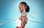 Black woman, water and cleaning body for health, skincare and beauty against blue mockup studio background. Splash, cosmetics and model with water splash for washing skin and wellness with mock up