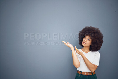 Buy stock photo Afro woman, showing hands and advertising space on grey studio background for marketing mockup, creative deal or mock up design. Brazilian model, pointing and promotion at gray backdrop for branding
