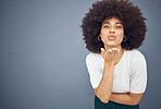Blow kiss, black woman and mockup showing love, smile and happy kissing with beauty. Model from New York with natural hair, happiness and mock up space loving romance and skincare wellness in studio