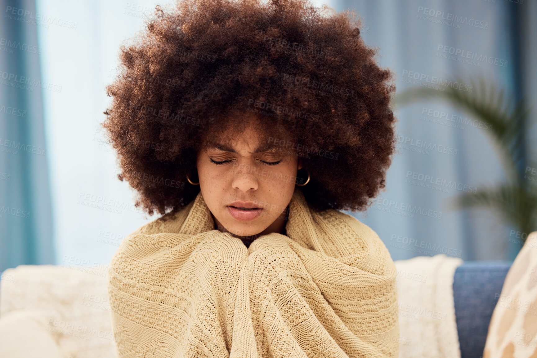 Buy stock photo Cold, winter and black woman with blanket on sofa to keep warm, cozy and stop shivering. Sick, covid and girl with flu symptoms sitting on couch freezing from low body temperature, illness and fever