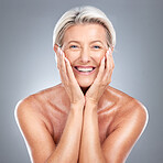 Skincare, smile and senior woman with a glow from dermatology against a grey studio background. Happy, smile and wellness face portrait of an elderly model with happiness  for beauty and cosmetics