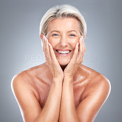 Buy stock photo Skincare, smile and senior woman with a glow from dermatology against a grey studio background. Happy, smile and wellness face portrait of an elderly model with happiness  for beauty and cosmetics
