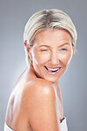Wink, funny and senior woman face happy about beauty, skincare and wellness. Portrait of an elderly model from Scandinavia with happiness of dermatology, skin health and anti aging treatment