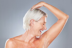Beauty, hygiene and woman in antiaging with skincare advertising, healthy skin and grooming with pose against grey studio background. Happy, senior model and natural cosmetics with body wellness.