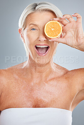 Buy stock photo Beauty, senior and woman fruit portrait for natural anti aging, skincare and vitamin c product. Health, wellness and mature skin detox model with excited face for advertising in gray studio.
