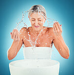 Splash beauty, senior and skincare for woman in studio for grooming, skin and hygiene on blue background mockup. Water splash, face and woman cleaning, washing and hydration, water and moisture care