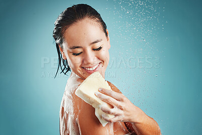 Buy stock photo Studio, skincare and woman in shower with sponge isolated on a blue background mockup. Water splash, cleaning or healthy hygiene of female model bathing, washing or showering for beauty and body care