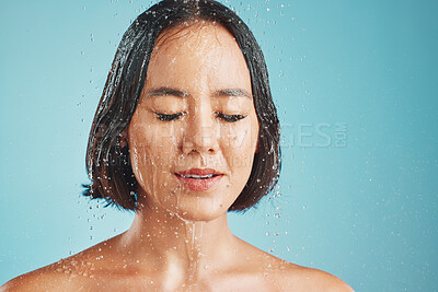 Buy stock photo Shower, studio and woman cleaning her face and hair for wellness with blue background and mockup space. Beauty, water and wet young girl washing and grooming for healthy hygiene or relaxed self care 