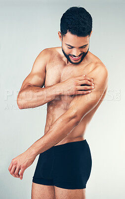 Buy stock photo Fitness, body of man and arm injury after intense workout, training or exercise on studio background. Accident, healthcare and topless male model suffering from joint inflammation or muscle pain.