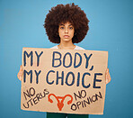 Protest, human rights and woman with a poster for abortion, body freedom and justice against a blue studio background. Choice, equality and portrait of an African girl with a board for a riot