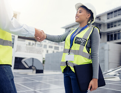 Buy stock photo Engineering team handshake, black woman at solar panel construction site or architecture project partnership. Working on building roof, industrial collaboration or contractor welcome employee