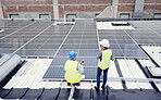 Engineer, planning and solar panel installation, maintenance and teamwork for renewable energy on a roof outdoor. Collaboration, planning and construction workers talking about clean or solar energy