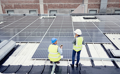 Buy stock photo Engineer, planning and solar panel installation, maintenance and teamwork for renewable energy on a roof outdoor. Collaboration, planning and construction workers talking about clean or solar energy