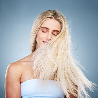 Buy stock photo Beauty, hair care and a woman on blue background with blonde, long and salon hair style. Health, wellness and luxury care for model hair, healthy mindset and color treatment with shampoo hair style.
