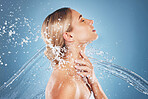 Water, skincare and profile woman on blue background for wellness, beauty and facial cleanse. Body care, spa and girl model with splash in studio for moisturizing products, hydration and healthy skin